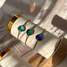 Elegant sea glass cuff bracelets in blue, green, and heavenly colors with gold-tone accents and gemstone details.