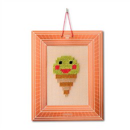 Embroidery kit featuring a cute, smiling ice cream design in a colorful, wooden frame.