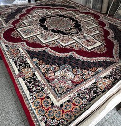 Large dark blue area rug with intricate floral and geometric patterns, suitable for living rooms or bedrooms.