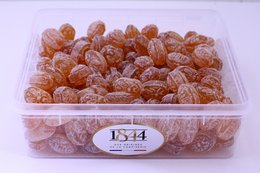 Honey-flavored lozenges in a 1kg container. Soft, chewy texture with a sweet, floral honey taste.