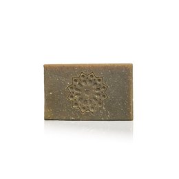 Amber-colored solid soap with a relaxing scent and a decorative floral design embossed on the surface.