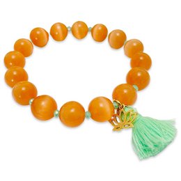 "Boho bracelet with cat's eye - orange, made of round orange beads with a green tassel charm."
The image shows a bracelet made of round, orange-colored beads that appear to be made of a semi-precious stone like cat's eye. The bracelet has a green tassel charm attached to it, adding a bohemian, festival-inspired style. The bracelet would be suitable for casual or festival-themed outfits, complementing the vibrant orange color and natural material.