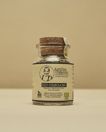 Glass jar containing organic oregano spice, with intense aroma and flavor.