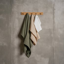 Soft, absorbent waffle-textured bathroom towels available in a variety of sizes and neutral colors including pure white, almond brown, stone green, storm blue, and sand brown.