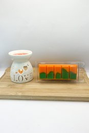 Pumpkin spice wax melt, orange and green rectangular wax melt tray, ceramic wax warmer with "Love" text.