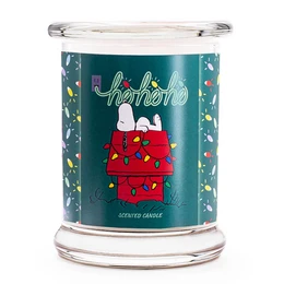 Scented candle with a festive Peanuts design, featuring Snoopy and Woodstock in a Christmas-themed illustration. The candle is 250g in size and has a warm, cozy scent.