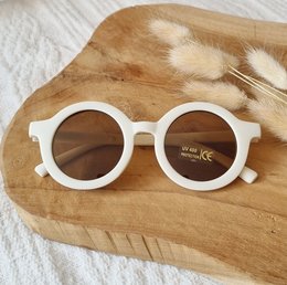 Round, beige children's sunglasses with UV400 protection.