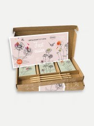 A gift box with the text "You made me grow" on the packaging, designed for teachers. The box contains various items such as soaps, candles, and other gifts.