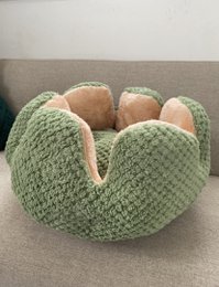 Soft, plush green cat bed with a circular design and raised edges to provide a cozy, comfortable sleeping space for your feline friend.