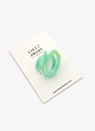 Green hair clip with a wavy design, made of a durable plastic material.