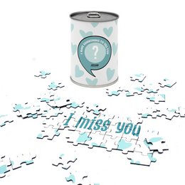  "A puzzle with the message 'I miss you' in a tin can, surrounded by puzzle pieces."