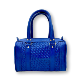 A blue, handmade leather handbag with a woven pattern and two handles.