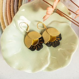 Matte gold and black leather drop earrings with a cherry blossom design.