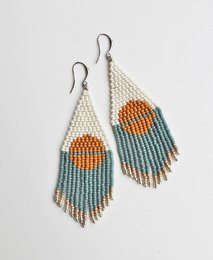 Beaded statement earrings with a sun and moon design in shades of white, orange, and blue.