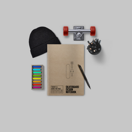 Skateboard-themed stationery notebook with a black skateboard graphic, a skateboard truck, and colorful markers.