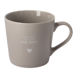  A light gray ceramic mug with the text "The best" printed on it. The mug has a simple, minimalist design with a heart-shaped icon.