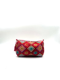 Red quilted toiletry bag with geometric diamond pattern, colorful embroidered details, small travel pouch.
