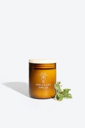 Tall, round scented candle in a golden glass jar with a label featuring a bee icon. The candle has a fresh, natural fragrance.