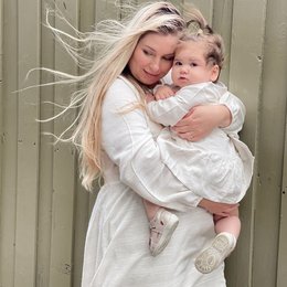 White linen midi dress for a young girl, featuring a ruffled hem and a relaxed, comfortable fit.