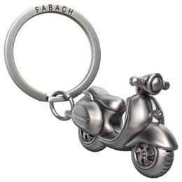  "Antique silver, bronze, or rose gold Vespa-style scooter keychain for scooter drivers and Vespa fans."

The product images show a metal keychain in the shape of a Vespa-style scooter. The keychain is available in three color variants: antique silver, antique bronze, and antique rose gold. The keychain features detailed sculpting of the scooter design, including the distinctive Vespa body shape and wheels. This keychain would make an ideal gift for scooter enthusiasts or Vespa fans.