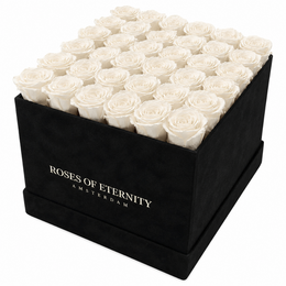 A square black box filled with vibrant red roses, with the text "Roses of Eternity Amsterdam" printed on the side.
The image shows a square black box filled with a grid of lush, deep red roses. The roses appear to be fresh and high-quality, with full, velvety petals. The box is labeled "Roses of Eternity Amsterdam", indicating this is a product or brand name.