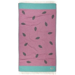 A pink and teal beach towel with a watermelon print pattern. The towel is made of 100% cotton and is OEKO-TEX certified.