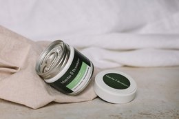 Ceremonial grade matcha tea in a tin container. The matcha powder is a vibrant green color and the tin has a white label with the brand name "Shēdo" printed on it.