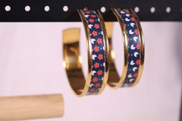 Chūrippu Japanese pattern hoop earrings with colorful gemstones in a gold-tone metal setting.