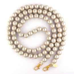 A delicate silver-toned necklace featuring a strand of small, round beads. The necklace has a simple, elegant design that would complement a variety of outfits.
