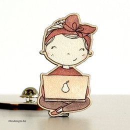 Wooden pin brooch with a cute girl illustration, featuring a red bow and a laptop-like device.