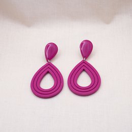 Vibrant magenta statement earrings with a teardrop shape and glossy finish.