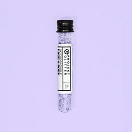  Fine purple eco glitter makeup product with a fluffy, round applicator.