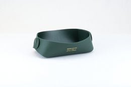 Storage tray made of imitation leather in sand and jungle green colors, suitable for storing various items.