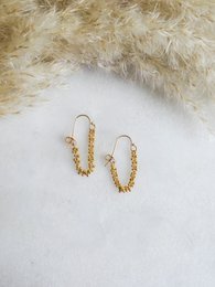 Gold-toned stud earrings with a textured, twisted design.