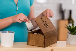 Handmade oak wood tea box with a tea leaves motif in brown color.