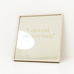 Square mirror with natural oak, white oak, or matte black aluminum frame. Available in 30x30 cm or 50x50 cm sizes, with or without wall mount. Features the text "I am a soul, this is my body" printed on the mirror.