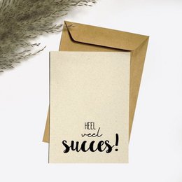 Greeting card with the text "Hello and success!" printed on a beige background. The card is enclosed in a gold envelope.