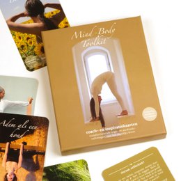 A unique Christmas gift set containing a mind-body toolkit, coach and inspiration cards, and a yoga and meditation deck. The set includes various tools for self-care and personal growth.