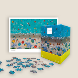 Colorful puzzle with art print depicting a beach scene with various beach items and people.
The puzzle features a vibrant beach scene with a variety of colorful beach items and people. The image shows a sandy beach with waves and a bright blue sky. There are various beach accessories such as beach balls, umbrellas, and floats scattered throughout the scene. The puzzle also includes people enjoying the beach environment.